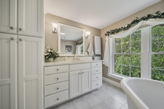 109 Temple Rd, Wilton, NH 03086 - bathroom featuring vanity, a freestanding bath, tile patterned floors, and baseboards