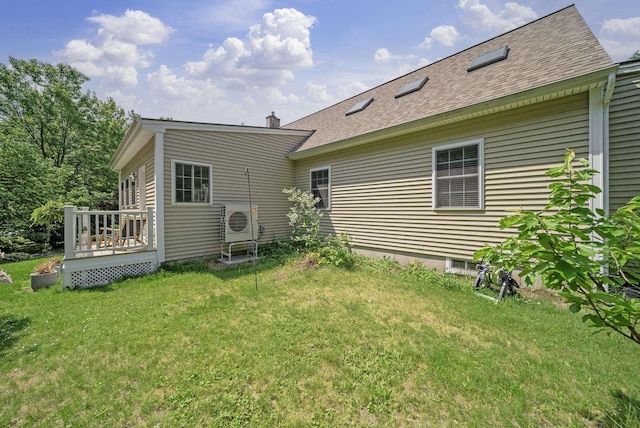 109 Temple Rd, Wilton, NH 03086 - back of house featuring a yard, a cooling unit, a deck, and a shingled roof