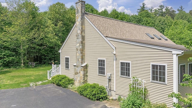 109 Temple Rd, Wilton, NH 03086 - view of property exterior featuring a yard, a chimney, and a shingled roof