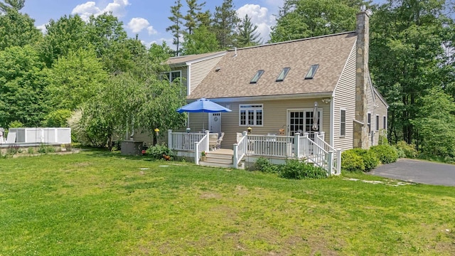 109 Temple Rd, Wilton, NH 03086 - back of house with a chimney, roof with shingles, a yard, and a deck
