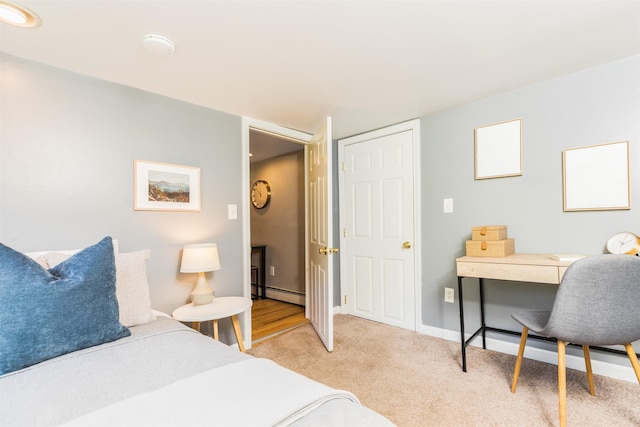 191 Washington St Unit 1, Dover, NH 03820 - carpeted bedroom featuring a baseboard radiator, a desk, and baseboards