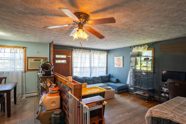 509 Cedar St, Manchester, NH 03103 - living area with a textured ceiling, a wall mounted air conditioner, a ceiling fan, healthy amount of natural light, and baseboard heating