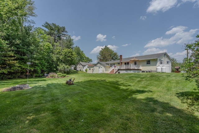 42 Bennett Bridge Rd, Northwood, NH 03261 - view of green lawn with an outdoor fire pit and a deck