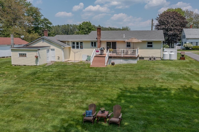 42 Bennett Bridge Rd, Northwood, NH 03261 - back of property with a wooden deck, a lawn, a chimney, and a shingled roof