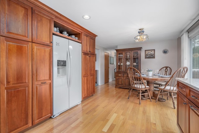 42 Bennett Bridge Rd, Northwood, NH 03261 - kitchen featuring white fridge with ice dispenser, brown cabinets, light wood finished floors, a chandelier, and recessed lighting