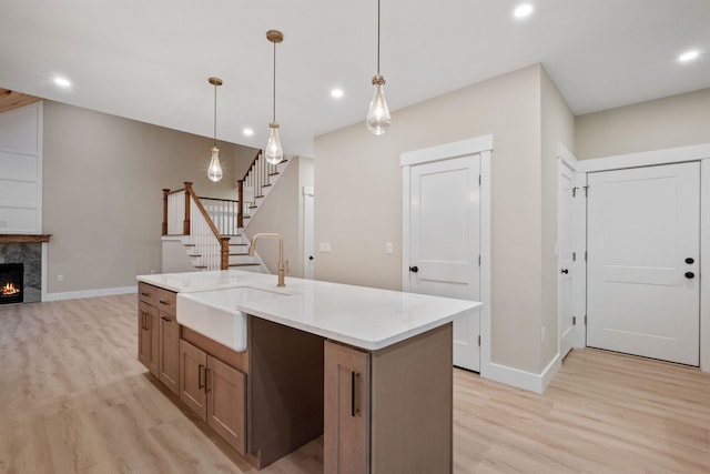 288 Sterling Dr, Laconia, NH 03249 - kitchen featuring a sink, light wood-type flooring, recessed lighting, baseboards, and an island with sink
