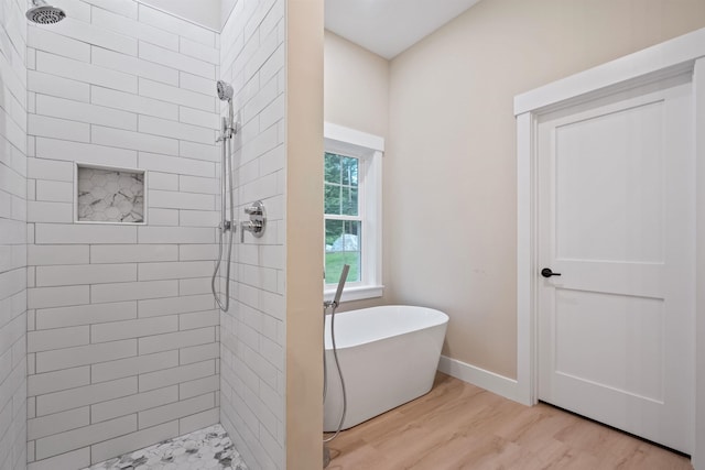 288 Sterling Dr, Laconia, NH 03249 - bathroom with wood finished floors, tiled shower, and a freestanding bath
