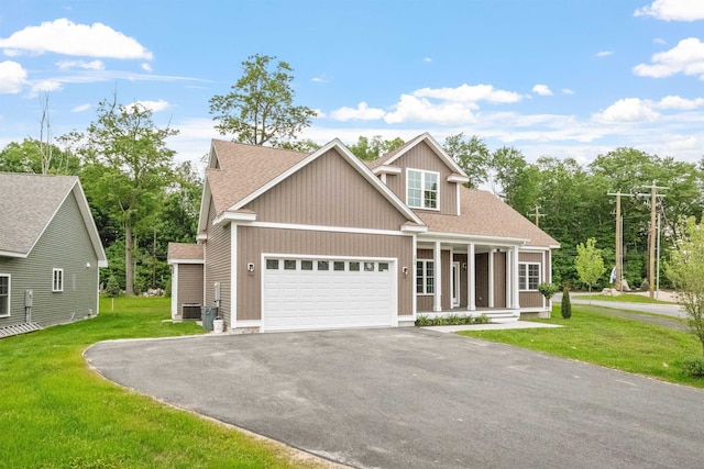 288 Sterling Dr, Laconia, NH 03249 - view of front facade with asphalt driveway, covered porch, roof with shingles, and a front yard