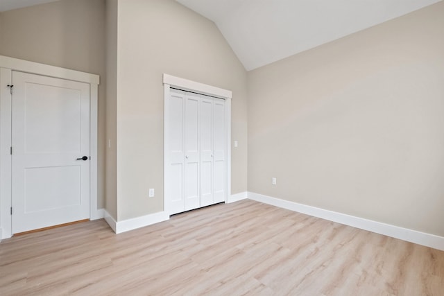 288 Sterling Dr, Laconia, NH 03249 - unfurnished bedroom featuring high vaulted ceiling, light wood finished floors, baseboards, and a closet