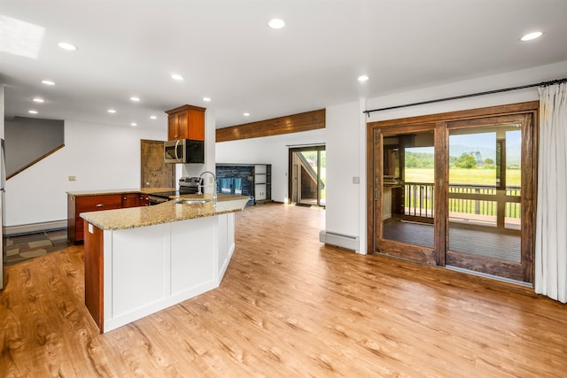 210 Field Rd Unit 44, Stowe, VT 05672 - kitchen featuring stainless steel appliances, a baseboard heating unit, light wood-style flooring, recessed lighting, and a peninsula