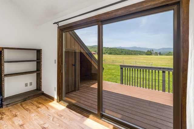 210 Field Rd Unit 44, Stowe, VT 05672 - doorway to outside with a view of rural / pastoral area, a mountain view, lofted ceiling, and wood finished floors