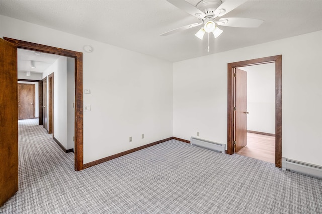 210 Field Rd Unit 44, Stowe, VT 05672 - unfurnished room with a baseboard radiator, light colored carpet, ceiling fan, and baseboards