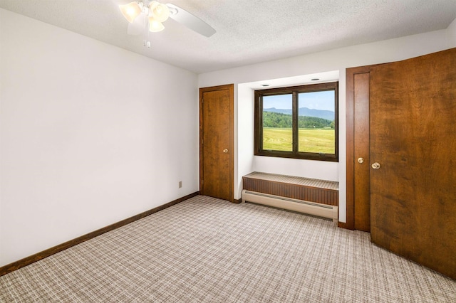 210 Field Rd Unit 44, Stowe, VT 05672 - unfurnished bedroom featuring baseboard heating, light carpet, and baseboards