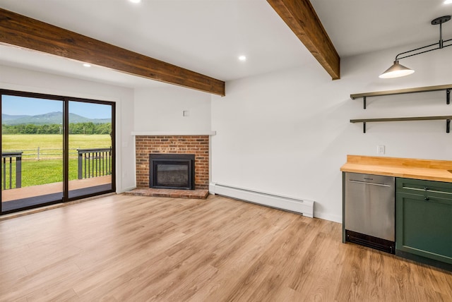210 Field Rd Unit 44, Stowe, VT 05672 - unfurnished living room with baseboard heating, beamed ceiling, light wood-style flooring, a mountain view, and recessed lighting