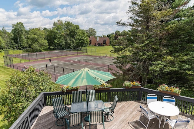 210 Field Rd Unit 44, Stowe, VT 05672 - wooden deck featuring outdoor dining area, a tennis court, and view of wooded area