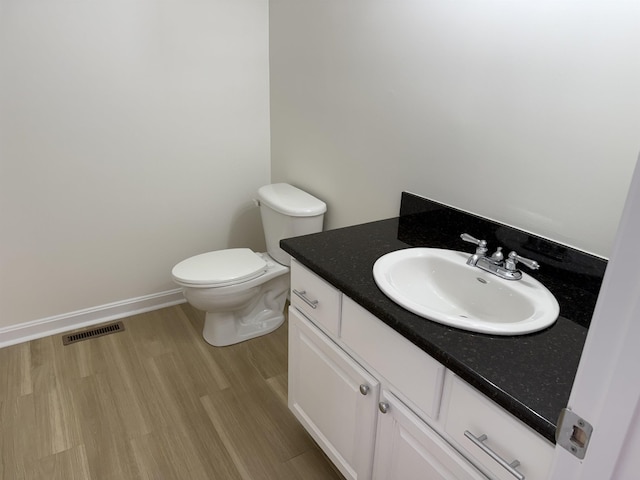 106 Karatzas Ave, Manchester, NH 03104 - bathroom featuring vanity, toilet, and wood finished floors