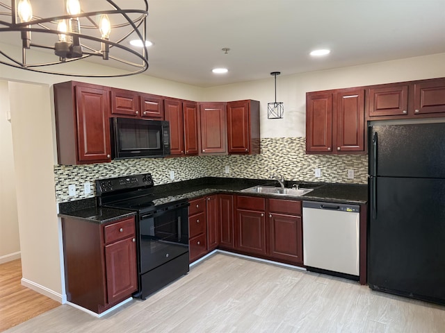 106 Karatzas Ave, Manchester, NH 03104 - kitchen featuring black appliances, a sink, reddish brown cabinets, light wood-style floors, and recessed lighting
