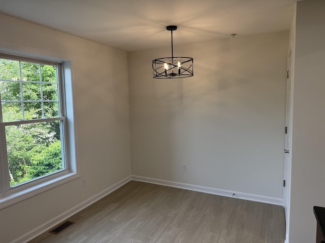 106 Karatzas Ave, Manchester, NH 03104 - unfurnished room with light wood finished floors, healthy amount of natural light, baseboards, and a chandelier