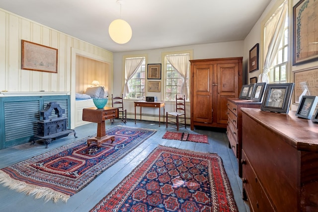 4 Quechee Rd, Hartland, VT 05048 - office with a wood stove, a baseboard heating unit, healthy amount of natural light, and dark wood-style floors