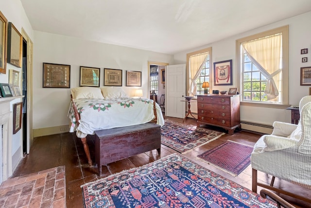 4 Quechee Rd, Hartland, VT 05048 - bedroom with a baseboard heating unit, baseboards, and wood finished floors