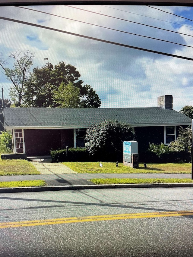 26 W Webster St, Manchester, NH 03104 - view of front of property with a chimney, a front yard, and a shingled roof