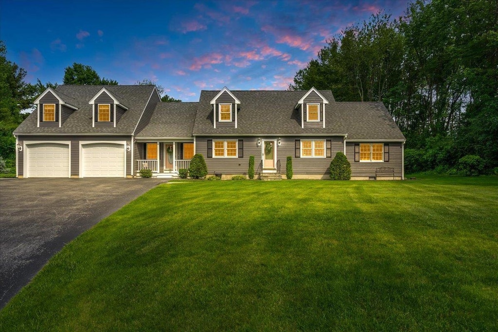 14 Nathaniel Dr, Hudson, NH 03051 - cape cod-style house with driveway, a front yard, a garage, and a shingled roof