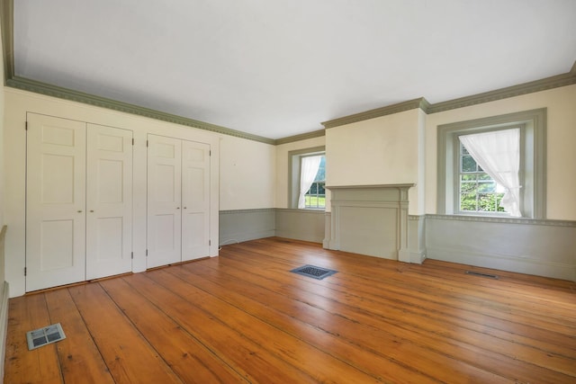 1519 New Boston Rd, Francestown, NH 03043 - unfurnished living room featuring ornamental molding, plenty of natural light, wainscoting, and hardwood / wood-style floors