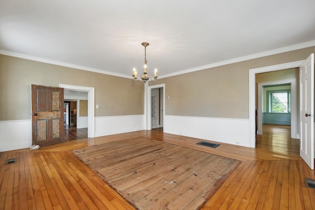 1519 New Boston Rd, Francestown, NH 03043 - empty room featuring wood-type flooring, a chandelier, wainscoting, and ornamental molding
