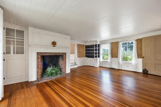 1519 New Boston Rd, Francestown, NH 03043 - unfurnished living room featuring wood finished floors, a fireplace, wainscoting, built in features, and wooden ceiling