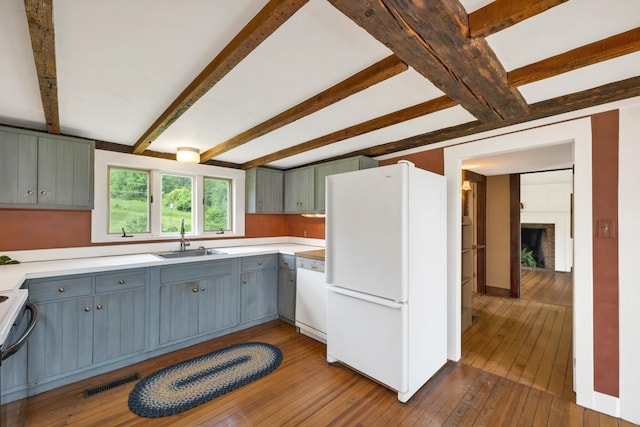 1519 New Boston Rd, Francestown, NH 03043 - kitchen with white appliances, a sink, dark wood finished floors, gray cabinetry, and beam ceiling