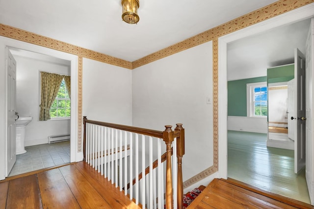1519 New Boston Rd, Francestown, NH 03043 - hall with an upstairs landing, a baseboard heating unit, hardwood / wood-style floors, and baseboards