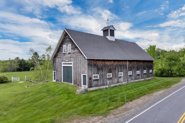 1519 New Boston Rd, Francestown, NH 03043 - view of home's exterior with a yard, a detached garage, a shingled roof, and a barn