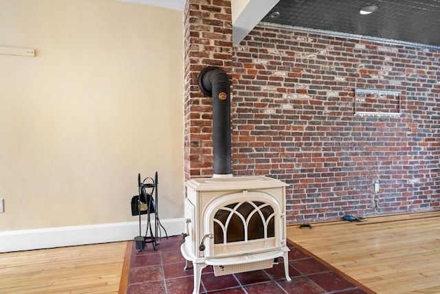 647 Canal St, Manchester, NH 03101 - detailed view of a wood stove, wood finished floors, and baseboards