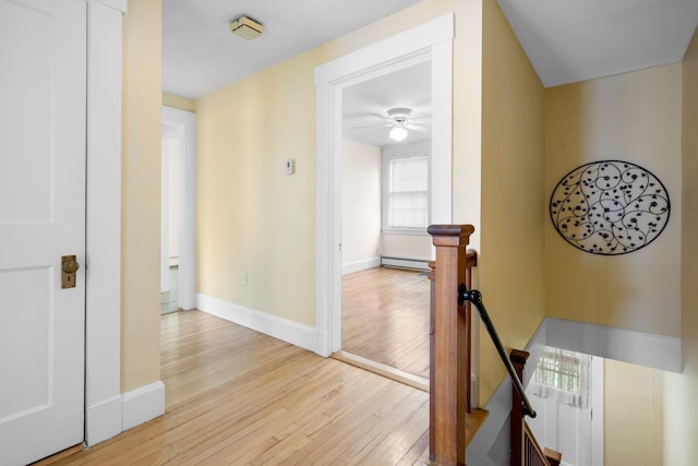 647 Canal St, Manchester, NH 03101 - hall with an upstairs landing, light wood finished floors, baseboards, and a baseboard radiator