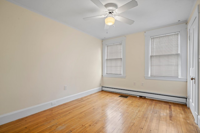 647 Canal St, Manchester, NH 03101 - empty room with baseboard heating, light wood finished floors, a ceiling fan, and baseboards