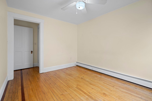 647 Canal St, Manchester, NH 03101 - empty room featuring a baseboard radiator, light wood-type flooring, baseboards, and ceiling fan