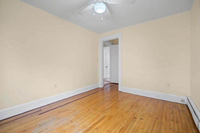 647 Canal St, Manchester, NH 03101 - empty room with a baseboard radiator, wood-type flooring, a ceiling fan, and baseboards