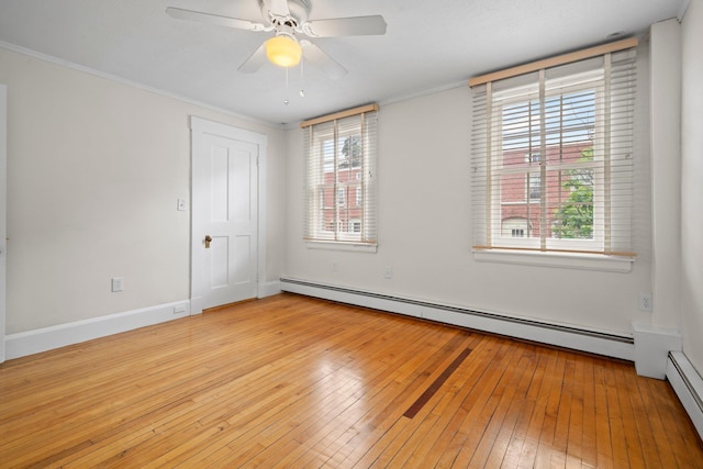647 Canal St, Manchester, NH 03101 - spare room with light wood-style floors, a baseboard radiator, a ceiling fan, baseboards, and ornamental molding