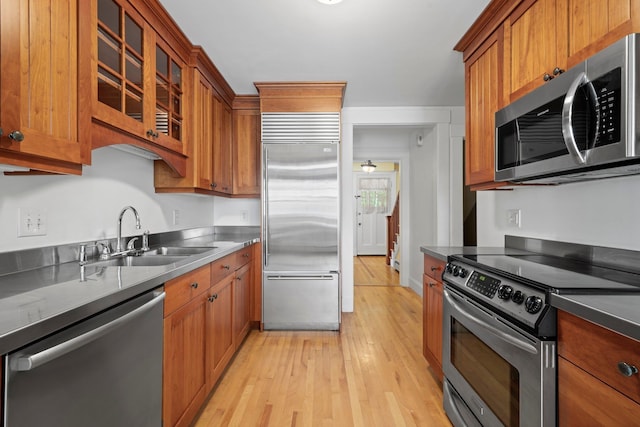 647 Canal St, Manchester, NH 03101 - kitchen featuring appliances with stainless steel finishes, a sink, stainless steel counters, and brown cabinets