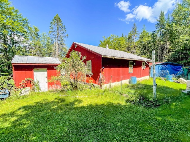 4823 Swamp Rd, Newbury, VT 05051 - view of property exterior featuring metal roof and a yard