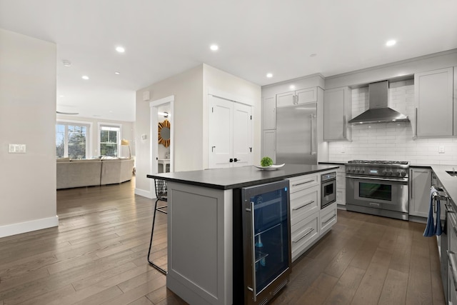 25 Little Bay Dr, Dover, NH 03820 - kitchen featuring wall chimney range hood, high quality appliances, wine cooler, a kitchen bar, and dark countertops