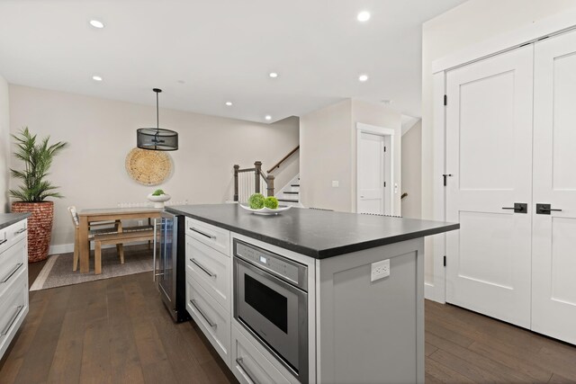 25 Little Bay Dr, Dover, NH 03820 - kitchen featuring dark countertops, wine cooler, dark wood-style floors, white cabinets, and recessed lighting
