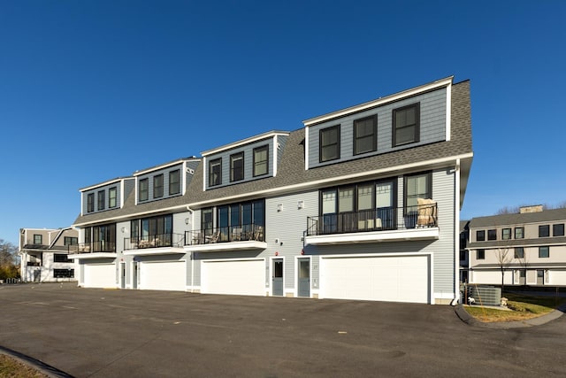 25 Little Bay Dr, Dover, NH 03820 - townhome / multi-family property with a shingled roof, a garage, central air condition unit, driveway, and a balcony