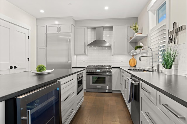 25 Little Bay Dr, Dover, NH 03820 - kitchen with beverage cooler, wall chimney range hood, a sink, high end appliances, and dark countertops