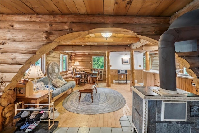 458 Woodcock Rd, Plainfield, VT 05667 - living room with rustic walls, wood-type flooring, a baseboard radiator, wood ceiling with exposed beams, and wainscoting