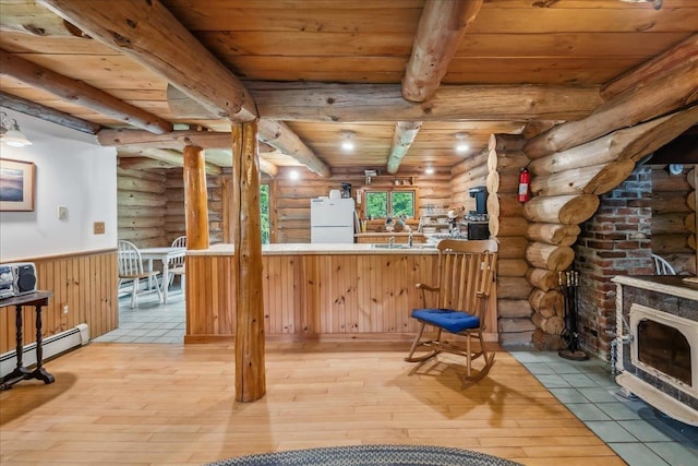 458 Woodcock Rd, Plainfield, VT 05667 - bar featuring freestanding refrigerator, log walls, wooden ceiling with exposed beams, light wood-type flooring, and wainscoting