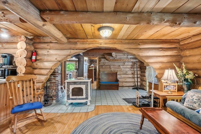 458 Woodcock Rd, Plainfield, VT 05667 - living room featuring a wood stove, wooden ceiling with exposed beams, wood-type flooring, log walls, and arched walkways