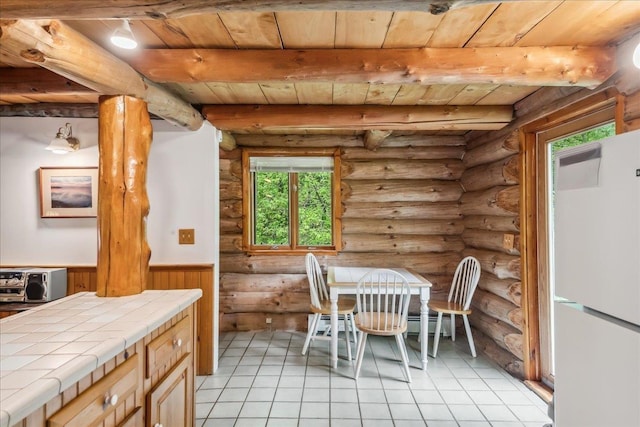 458 Woodcock Rd, Plainfield, VT 05667 - dining room with wood ceiling with exposed beams, log walls, wainscoting, and light tile patterned flooring