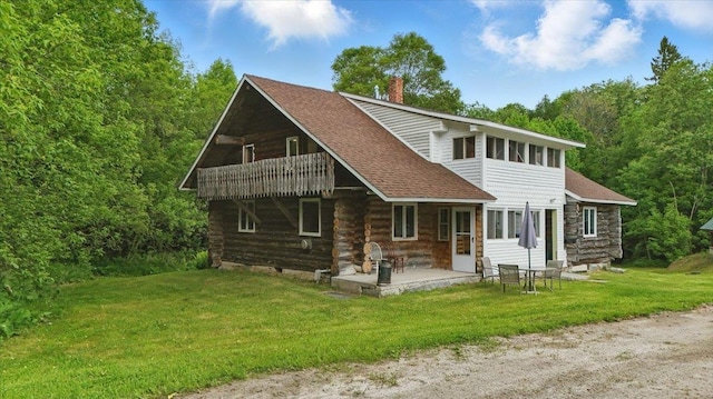 458 Woodcock Rd, Plainfield, VT 05667 - back of property with a chimney, roof with shingles, a lawn, a patio, and log exterior