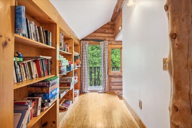 458 Woodcock Rd, Plainfield, VT 05667 - sitting room featuring hardwood / wood-style floors, vaulted ceiling, and rustic walls